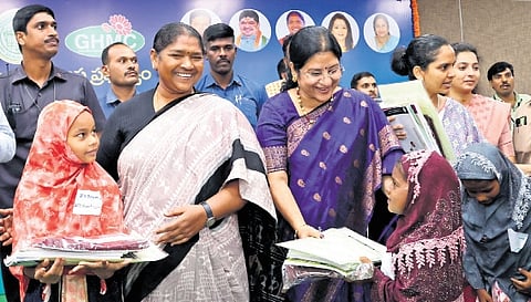 Women & Child Welfare Minister Dansari Anasuya hands over cheques to members of Self-Help Groups at the Praja Bhavan in Hyderabad on Friday