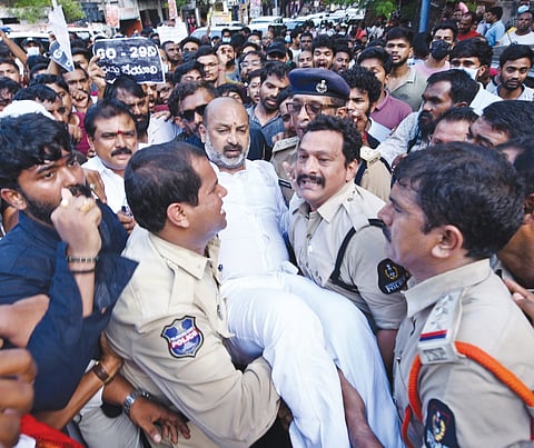 Police personnel take Minister of State for Home Affairs Bandi Sanjay into preventive custody as they disperse protesters taking part in a “Chalo Secretariat” rally in Hyderabad on Saturday