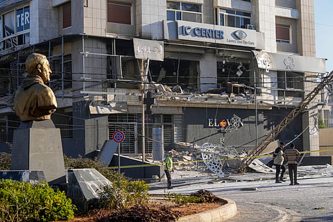 A bust of late Iranian General Qassem Soleimani, stands in front of a destroyed branch of the Hezbollah-run Qard al-Hassan at the site of an Israeli airstrike in Dahiyeh, Beirut, Lebanon, Monday, Oct. 21, 2024.