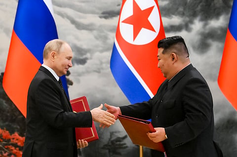 Russian President Vladimir Putin, left, and North Korea's leader Kim Jong Un exchange documents during a signing ceremony of the new partnership in Pyongyang, North Korea, on June 19, 2024.