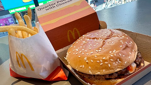 A McDonald's Quarter Pounder hamburger and fries are shown in this photograph.