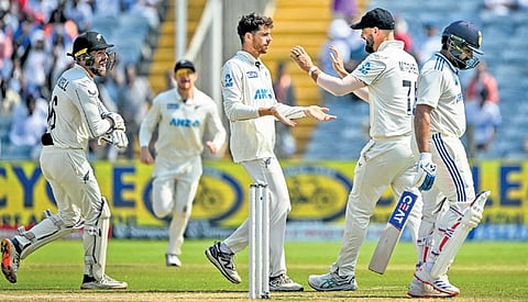New Zealand players celebrate Rohit Sharma’s wicket in Pune on Saturday