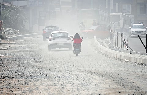 Commuters struggle on the dusty, pothole-ridden Dr Vishnuvardhan Road in Bengaluru South which connects Mysuru Road and Uttarahalli