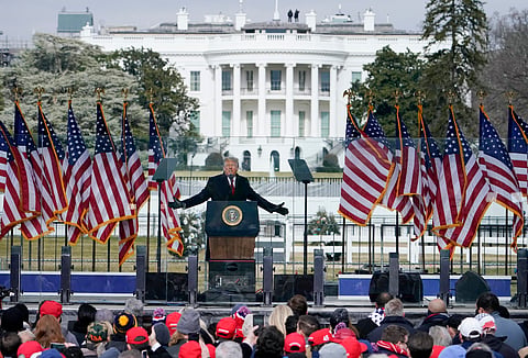 With the White House in the background, President Donald Trump speaks at a rally in Washington, Jan. 6, 2021.