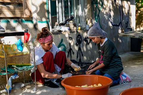 Volunteers prepare meals at a women's art center that was turned into a kitchen for displaced people who fled southern Lebanon amid the ongoing Hezbollah-Israel war, in the town of Aqaibe, northern Lebanon, Thursday, Oct. 24, 2024.