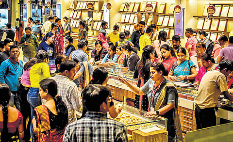 Customers buying jewellery at a showroom in Bhubaneswar on the occasion of Dhanteras on Tuesday