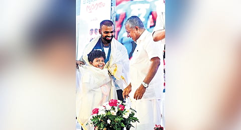 Chief Minister Pinarayi Vijayan offering a ponnada to Sreeansh, son of former captain of Indian hockey team P R Sreejesh, at Jimmy George Indoor Stadium in Thiruvananthapuram