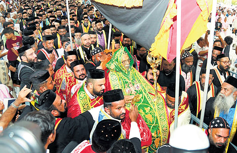 Bishops and priests participate in the procession carrying the mortal remains of Baselious Mor Thomas I