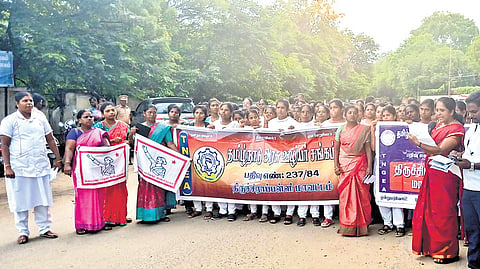 Healthcare workers staging a protest in Tiruchy on Monday