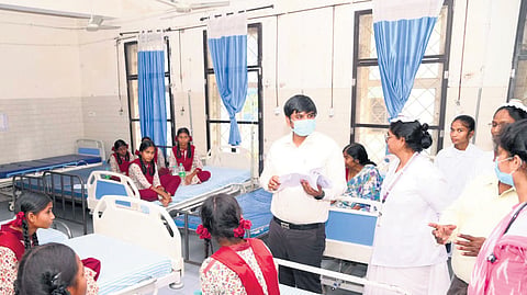 District Collector Kumar Deepak enquires with doctors about the health condition of the students at a hospital in Mancherial.