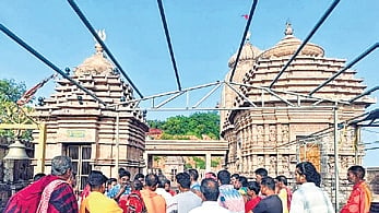 Servitors and locals at the temple entrance on Wednesday