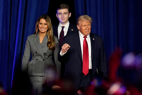 Republican presidential nominee former President Donald Trump, joined by, from right, Melania Trump and Barron Trump, arrives to speaks at an election night watch party, Wednesday, Nov. 6, 2024, in West Palm Beach, Fla.
