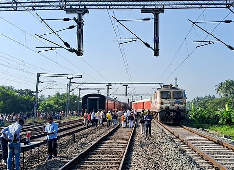 People gather after three coaches of the Secunderabad-Shalimar Superfast Express train derailed near Howrah, West Bengal.