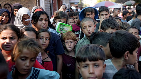 Palestinians line up for food distribution in Deir al-Balah, Gaza Strip, on Oct. 17, 2024.