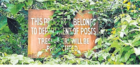 The board erected on the allotted 10-cent plot states that the land belongs to the postal department