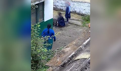The screengrab from the video showing the girl washing noon meal utensils.
