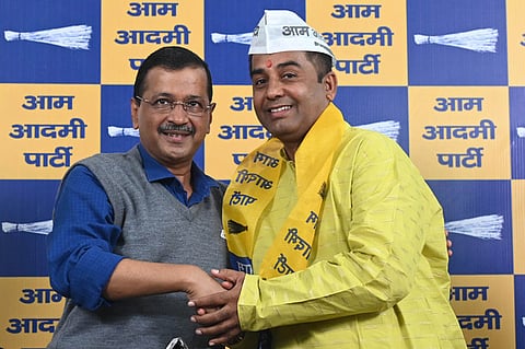 AAP national convener Arvind Kejriwal with former BJP MLA Anil Jha after the latter joined the party, at the AAP office, in New Delhi on Sunday, Nov. 1