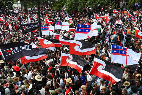 Thousands of people gather outside New Zealand's parliament to protest a proposed law that would redefine the country's founding agreement between Indigenous Māori and the British Crown.