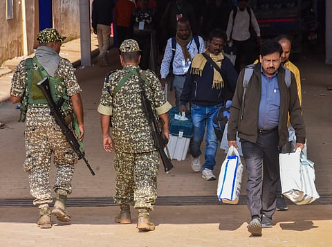 Polling officials with EVMs and other election materials leave for their respective polling stations as security personnel keep vigil on the eve of voting for the last phase of Jharkhand Assembly polls, in Ranchi, Tuesday, Nov. 19, 2024.