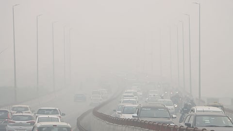 Commuters wade through dense smog as air quality dips in New Delhi.
