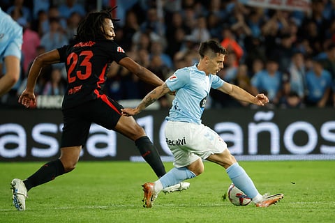 Celta's Alfon, right, is challenged by Barcelona's Jules Kounde during the Spanish La Liga soccer match between Celta Vigo and Barcelona at the Balaidos stadium