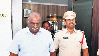 Retired CID Additional SP Vijay Paul being escorted to a court in Guntur on Wednesday