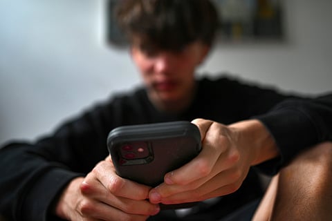 A teenager uses his mobile phone to access social media, Sydney, Wednesday, Nov. 13, 2024.