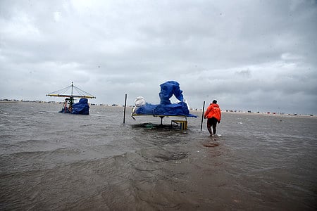 A person checks his shop at Marina ahead of Cyclone Fengal, in Chennai