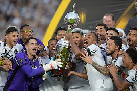 Players of Brazil's Botafogo hold the trophy as they celebrate after winning the Copa Libertadores final soccer match against Brazil's Atletico Mineiro at Monumental stadium in Buenos Aires, Argentina, Saturday, Nov. 30, 2024.