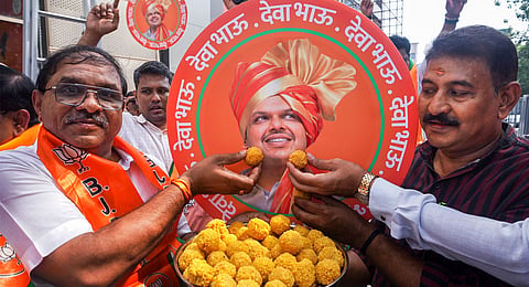 Supporters celebrate with sweets after Devendra Fadnavis was unanimously elected as BJP legislative party leader, paving the way for him to be sworn in as Maharashtra Chief Minister, in Thane, Mumbai, Wednesday, Dec. 4, 2024.