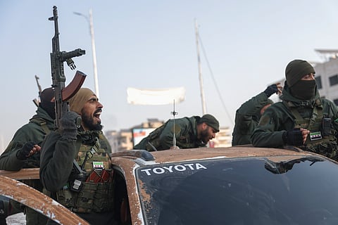 Syrian opposition fighters ride along the streets in the aftermath of the opposition's takeover of Hama, Syria, Friday, Dec. 6, 2024.