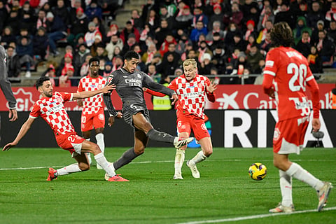 Real Madrid's English midfielder Jude Bellingham (C) scores the opening goal during the Spanish league football match between Girona FC and Real Madrid CF at the Montilivi stadium in Girona on December 7, 2024.