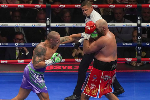 Boxers Britain's Tyson Fury, right, and Ukraine's Oleksandr Usyk compete during their WBA, WBO, and WBC world heavyweight title fight in Riyadh, Saudi Arabia, Saturday, Dec. 21, 2024.