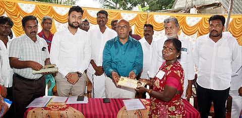 C Palani IAS distributes free pattas to a Irular tribal woman