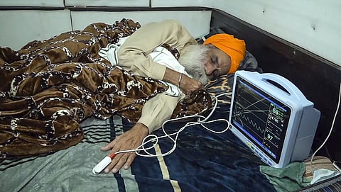 Farmer leader Jagjit Singh Dallewal rests during his hunger strike, at the Khanauri Border in Sangrur