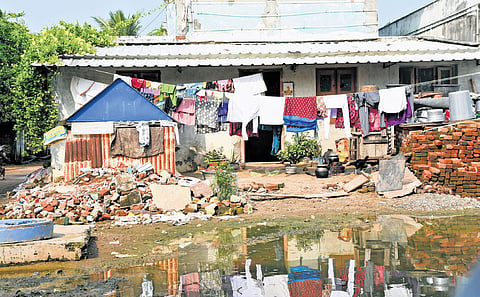 Another house in a dilapidated condition; women pay tribute to the victims of the tsunami, at the Marina Beach on Thursday.