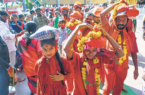 Devotees who took deeksha arrive at the Kanaka Durga temple for the relinquishment in Vijayawada on Monday.