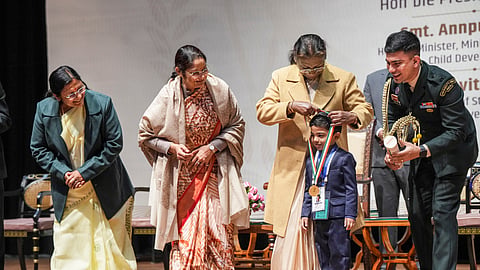 President Droupadi Murmu confers a Pradhan Mantri Rashtriya Bal Puraskar to Anish Sarkar, at the Rashtrapati Bhavan Cultural Centre in New Delhi on Thursday.