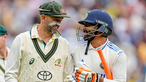 India's Ravindra Jadeja, right, talks to Australia's Nathan Lyon as they walk off the field on the end of play of the second day of the fourth cricket test between Australia and India.