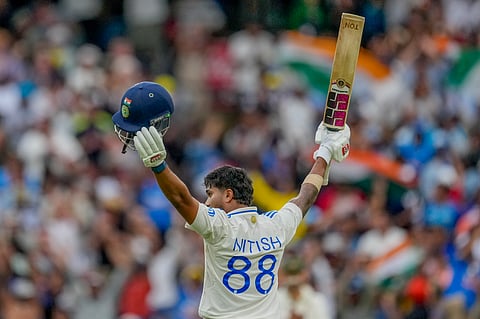India's Nitish Kumar Reddy raises his bat as he celebrates after scoring his century during play on the third day of the fourth cricket test between Australia and India at the Melbourne Cricket Ground, Melbourne, Australia, Saturday, Dec. 28, 2024.