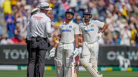 Yashasvi Jaiswal, center, speaks to umpires after being dismissed during play on the last day of the fourth cricket test between Australia and India at the Melbourne Cricket Ground.