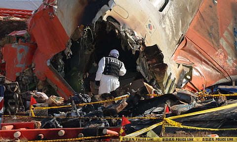 An official from the Ministry of Land, Infrastructure and Transport's Aviation and Railway Accident Investigation Committee takes part in the investigation at Muan International Airport, some 288 kilometres southwest of Seoul on Thursday.