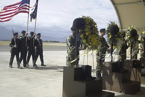 U.S. soldiers carry an American flag in a memorial service for five U.S. soldiers at the Soto Cano Airbase in Palmerola, north of Tegucigalpa, Dec. 14, 2002.
