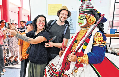 Celine and Ghislain from Canada take a selfie with a kathakali contestant at the 63rd State School Arts Festival at Cotton Hill Girls HSS in Thiruvananthapuram.