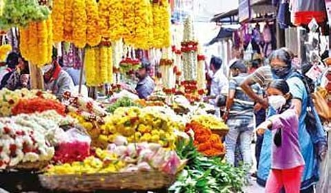 People shop at Gandhi Bazaar in Bengaluru