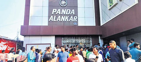 Locals gather in front of Panda Alankar shop in Panikoili