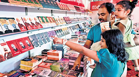 A family visiting the stall at the Kerala Legislature International Book Fair