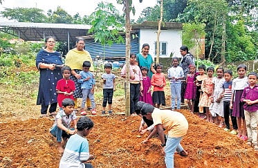 Teachers and students of Govt LP School prepare the land for cultivation