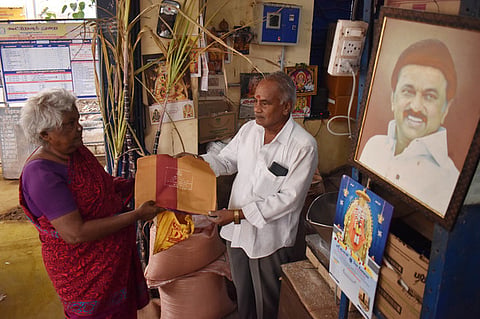 A woman beneficiary is receiving her free Saree along with Pongal gift hampers at a ration shop in Coimbatore.