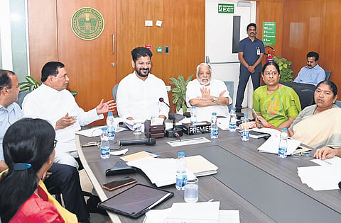 Chief Minister A Revanth Reddy shares a lighter moment with his Cabinet colleagues and senior Congress leaders during a review meeting in Hyderabad on Thursday